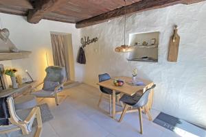 a dining room with a wooden table and chairs at Rustico Luna by HolAp SA in Brione sopra Minusio