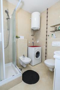 a bathroom with a washing machine and a washer at Val in Kaštela +41 photos