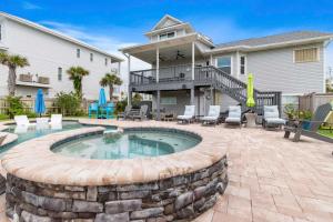 a patio with a swimming pool and a house at Gratitude Island in Navarre
