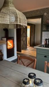 a kitchen with a table with a fireplace in it at Olletorp in Munkedal