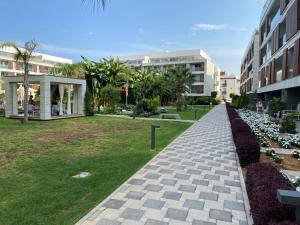a walkway in a park next to a building at Iskele Courtyard Long Beach Apartment in Iskele