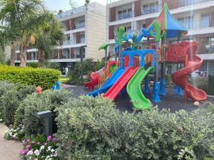 a playground in front of a building at Iskele Courtyard Long Beach Apartment in Iskele