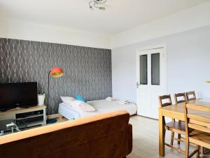 a living room with a couch and a tv at Peaceful City Centre Retreat at Great location and Easy Access in Edinburgh