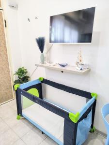 a blue and green bench with a shelf on a wall at SEA Studio Flat in Misano Adriatico