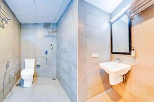 a bathroom with a toilet and a sink at Townhouse Oak Puducherry Airport in Puducherry