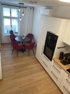 a kitchen and dining room with a table and chairs at Rožnov 23 Centrum in Rožnov pod Radhoštěm +5 photos