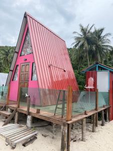 a house with a red roof on the beach at Redang Campstay A Frame in Redang Island