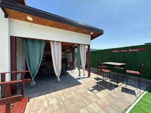 a patio with chairs and a table on a deck at Holiday Home Emma in Bihać