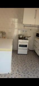 a kitchen with a white stove and a floor at Busumbala 88HP 326 Gambia in Busumbala