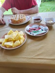 a table with three plates of food and waffles and waffle at Paradise Beach Appart with Kitchen by Casa in Kribi