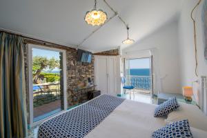 a bedroom with a bed and a view of the ocean at Hotel Costa Diva in Praiano