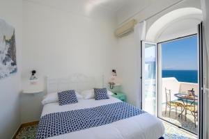 a bedroom with a bed with a view of the ocean at Hotel Costa Diva in Praiano +37 photos