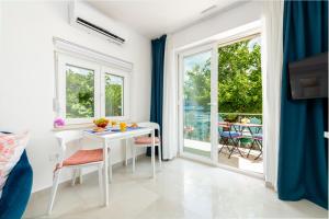 a room with a table and chairs and a balcony at Stylish sea view studio in Dubrovnik +9 photos