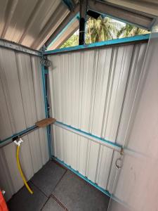 an outside view of a garage with a hose at Redang Campstay A Frame in Redang Island