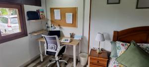 a bedroom with a desk and a bed with a desk and a chair at Roble Viejo Rural House 