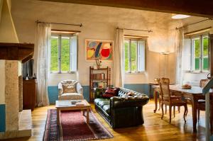 a living room with a couch and a table at Castello Di Postignano Relais in Sellano
