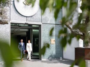 a man and a woman walking into a building at Sofitel Casablanca Tour Blanche in Casablanca