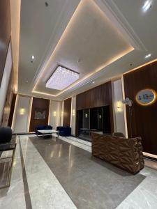 a lobby with a couch and chairs in a building at Vaelora Stay - Luxury Studio in Ghaziabad