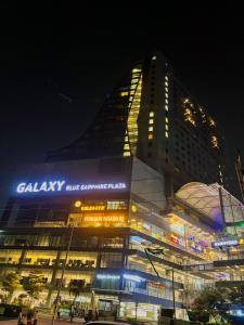 a large building with a sign on it at night at Vaelora Stay - Luxury Studio in Ghaziabad