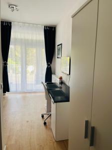 an office with a desk and a window at Sanssouci-FeWo 09 in Bad Kissingen