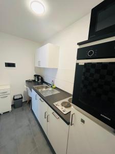 a kitchen with a sink and a stove top oven at Sanssouci-FeWo 09 in Bad Kissingen