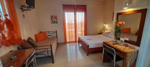 a small room with a bed and a living room at Golden Sun Apartments in Rovies