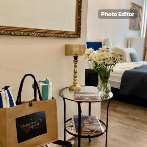 a room with a table with a bag and a bed at Hungaricum Budapest in Budapest