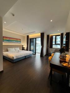 a large bedroom with a bed and a desk at Căn hộ studio 38m2 The Sapphire S2-0802 in Ha Long