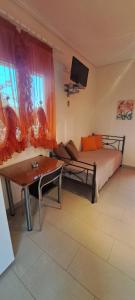 a living room with a bed and a couch at Golden Sun Apartments in Rovies