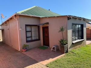 a small house with a door and a patio at The Tranquil Golden Retreat in Johannesburg