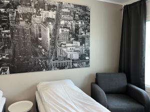 a bedroom with a bed and a chair at Hotelli Kontio in Kontiolahti