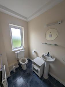 a bathroom with a toilet and a sink at Large 4 Bedroom 5 Bathroom Property in Galway