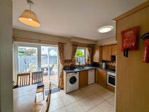 a kitchen with a table and a dishwasher at Large 4 Bedroom 5 Bathroom Property in Galway