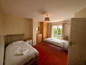 a bedroom with two beds and a window at Large 4 Bedroom 5 Bathroom Property in Galway