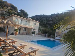 a villa with a swimming pool and a house at Villa petros in Malia