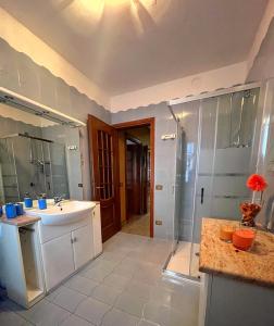 a large bathroom with a sink and a shower at LA PANORAMICA Svegliati con la Vista delle Alpi dalle Camere e Terrazza Ampia in Berzo +21 photos