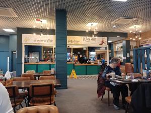 a woman sitting at a table in a restaurant at Wilerby Winchester in Heysham