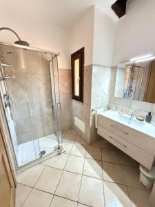 a bathroom with a shower and a sink at Villa Blue Horizon in Costa Paradiso