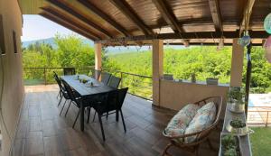a patio with a table and chairs on a balcony at Villa Hani in Sarajevo
