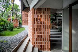 a brick wall on the side of a house at Blossom Eco Luxe Villas by Ekosistem in Canggu