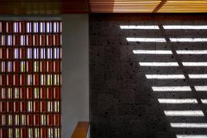 a room with a brick wall with sunlight streaming through the window at Blossom Eco Luxe Villas by Ekosistem in Canggu