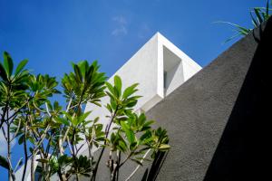 a white house with trees in front of it at Blossom Eco Luxe Villas by Ekosistem in Canggu