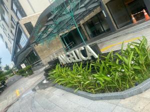 a hotel sign on the side of a building at Căn hộ 1PN VIEW HỒ BƠI CAO CẤP, FREE POOL, GYM in Gò Công