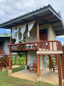 a deck on the side of a house at Doi Piang Dao Farm in Ban Tham +15 photos