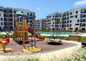 a playground with a slide at Martil Playa Haut standing in Martil