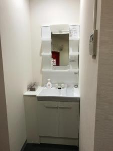 a bathroom with a white sink and a mirror at HOTEL LEOLA - Vacation STAY 25772v in Osaka
