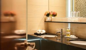a bathroom with two sinks and a mirror at Acappella Kuala Lumpur City Centre in Kuala Lumpur +34 photos