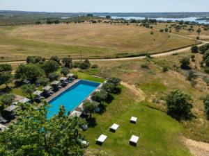 an aerial view of a villa with a swimming pool in a field at Herdade da Cortesia Hotel in Avis +82 photos