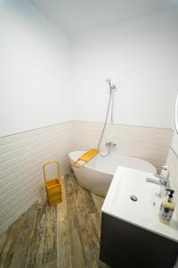 a bathroom with a white tub and a sink at CristAlex Sunset in Constanţa +13 photos