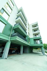 an apartment building with balconies and a parking lot at CristAlex Sunset in Constanţa